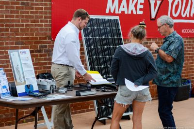 Attendees at the 2017 Southwest Virginia Solar Fair discuss about solar panels .