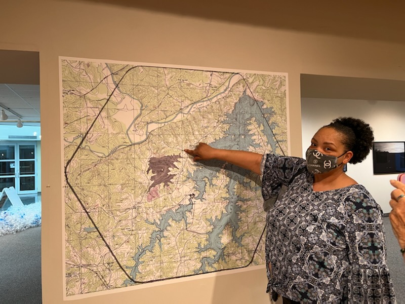Woman points to location on a map.