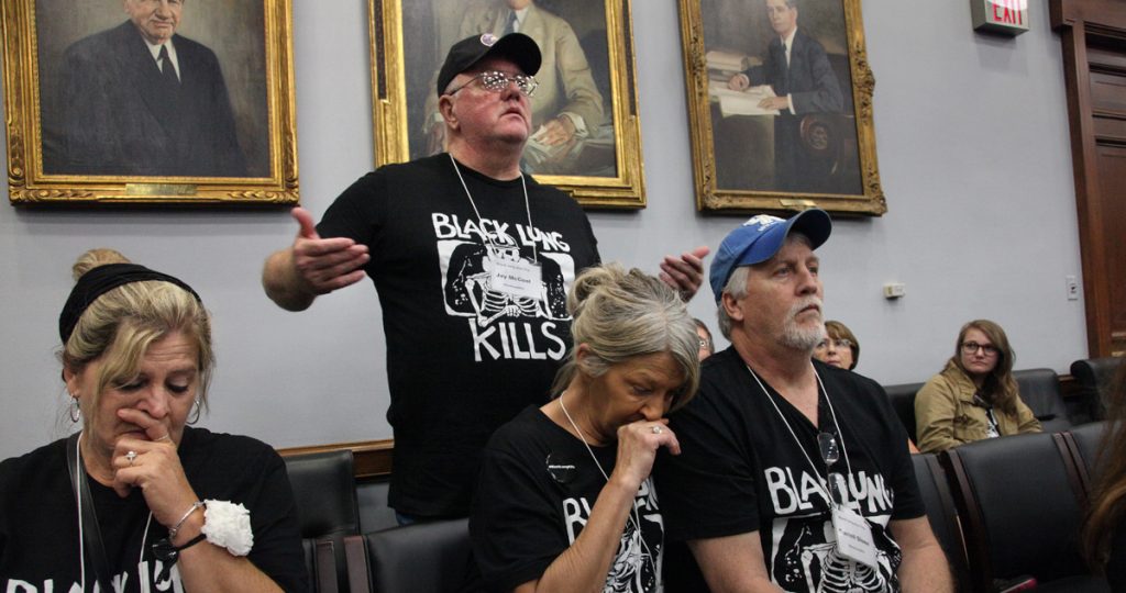 Images shows miners wearing black lung kills t-shirts lobbying Congress