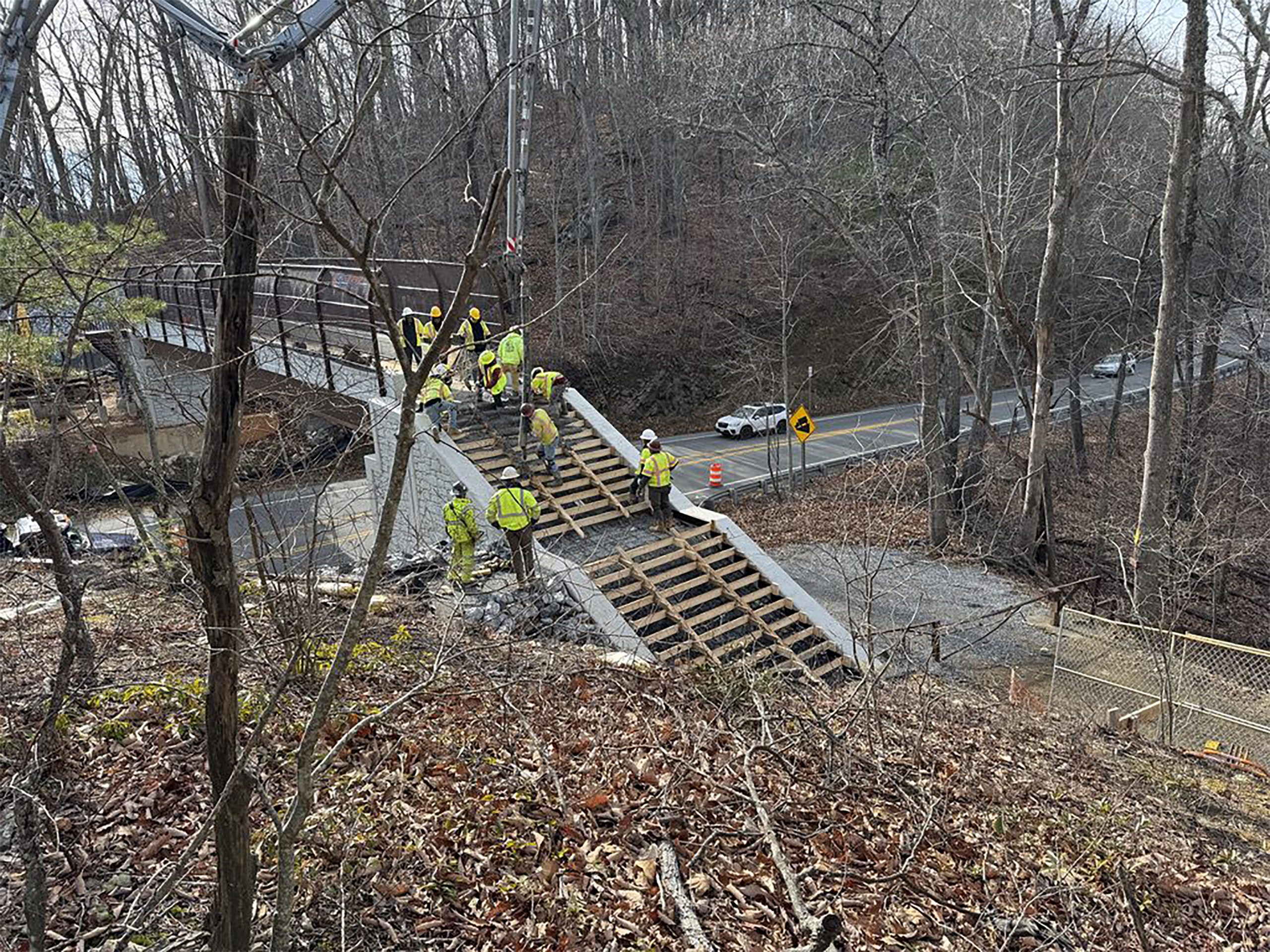 Workers pour concrete to form stairs coming down from the pedestrian bridge from the McAfee Knob trailhead parking lot across Virginia 311. Photo by Dan Radmacher.