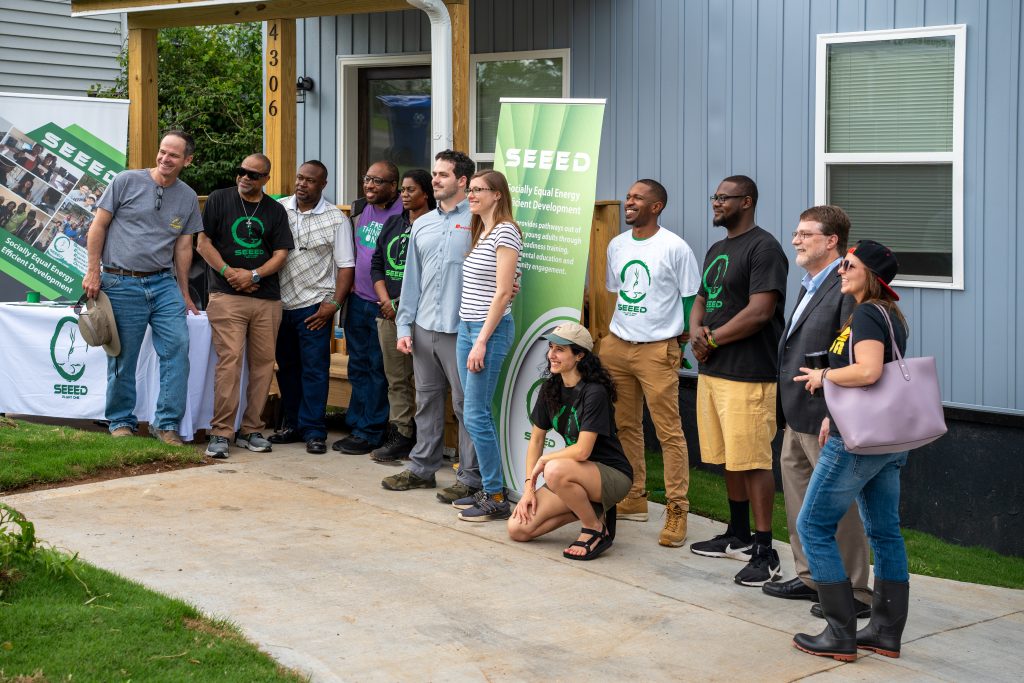 Homeowners Shawn O'Brien and Nicole Yacura at the ribbon-cutting ceremony for their home with representatives from SEEED, ORNL and other partners. Photo by Abby Hassler.