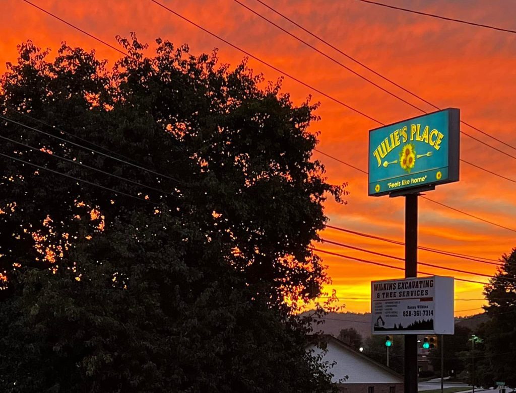 Sunset framing restaurant sign that reads "Julie's Place."
