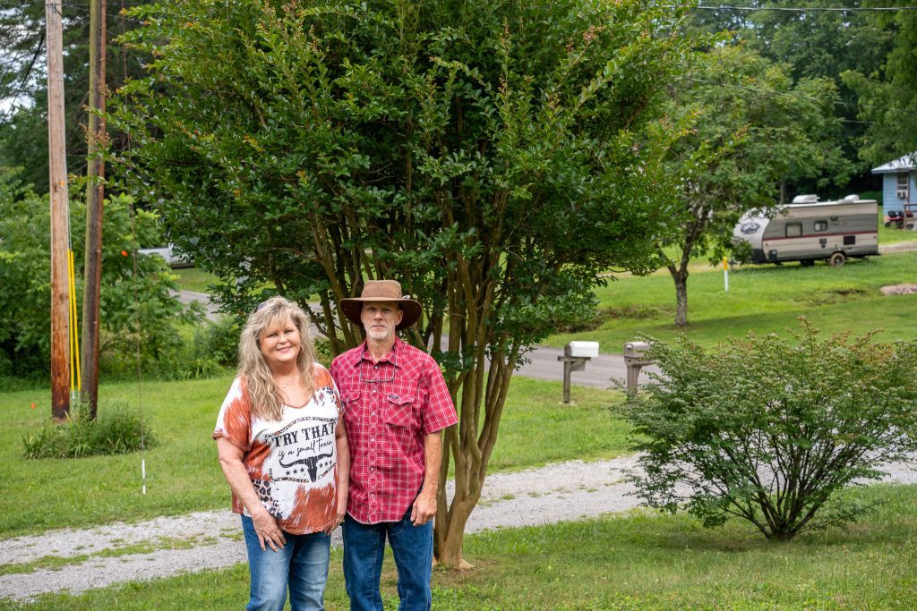 Patricia Smarsh and Jeffrey Gilliam stand in front of their crepe myrtles. Photo by Abby Hassler