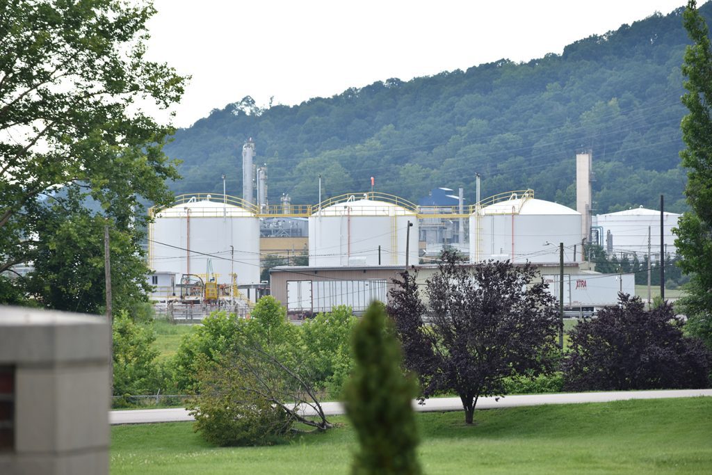 Tanks from Institute’s Dow Chemical plant peek through the trees behind West Virginia State University’s campus. Photo by Joe Severino