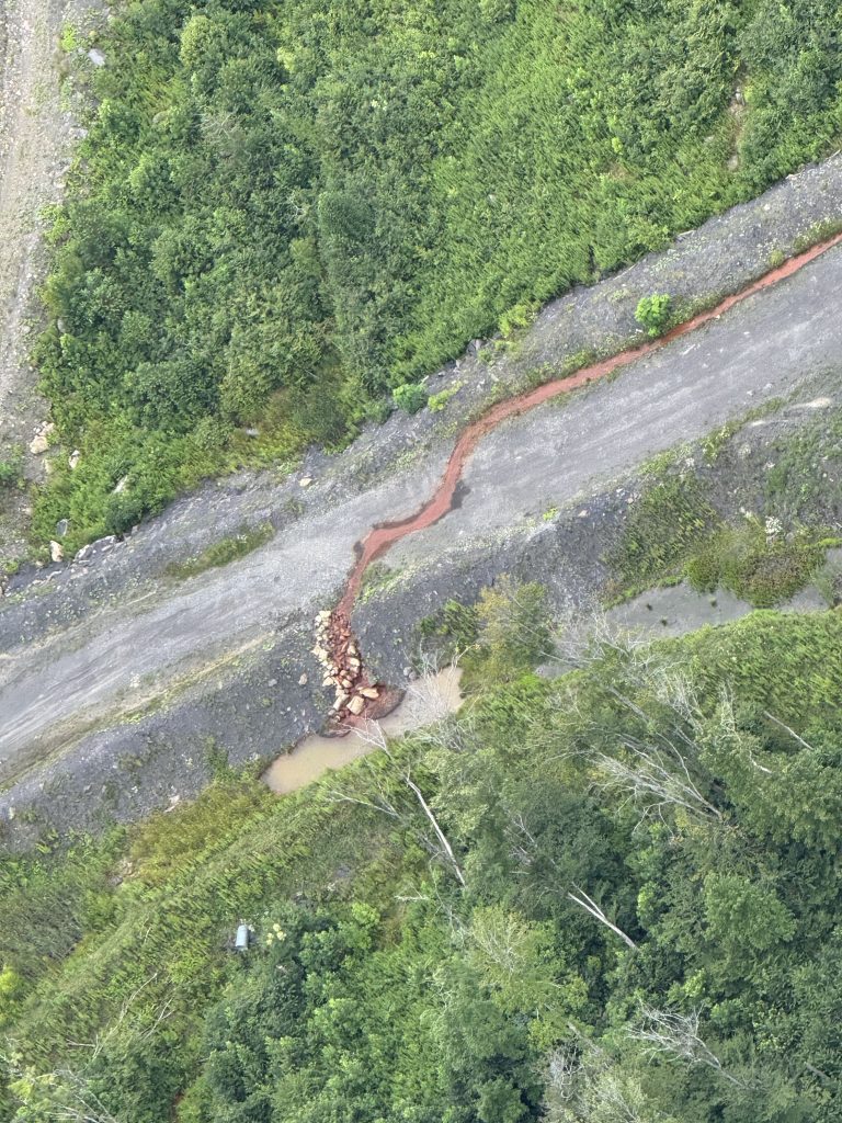 Orange water, indicative of acidity and high levels of iron, discharging from South Fork Coal's Lost Flats mine, flowing towards the South Fork of Cherry River, on Aug. 5, 2025. Photo by Andrew Young of Allegheny-Blue Ridge Alliance