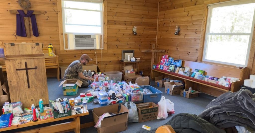 Willie with donated aid supplies in a Yancey County church after Hurricane Helene. Photo by Jimmy Davidson