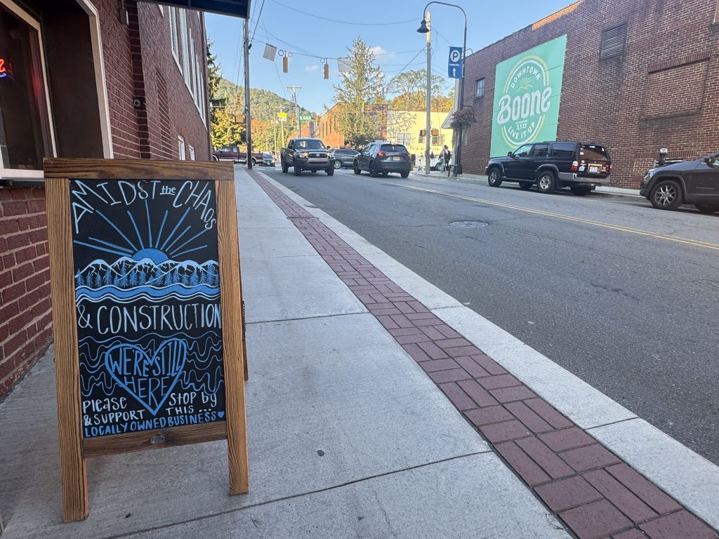 A sign outside of Benchmark Provisions Beer and Wine in downtown Boone, North Carolina, on Sept. 22. That day, Boone Chamber of Commerce President & CEO David Jackson testified before the Senate Committee on Small Business & Entrepreneurship about positive aspects of the federal response and areas for improvement. Photo by Molly Moore