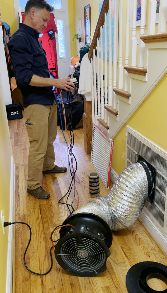 Virdiant's Home Energy Auditor Andrew Grigsby conducts an air duct leakage test on the author's HVAC system.