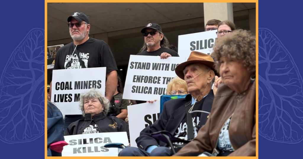A group of people gather outside a government building holding signs calling for silica rule enforcement and miner protection.