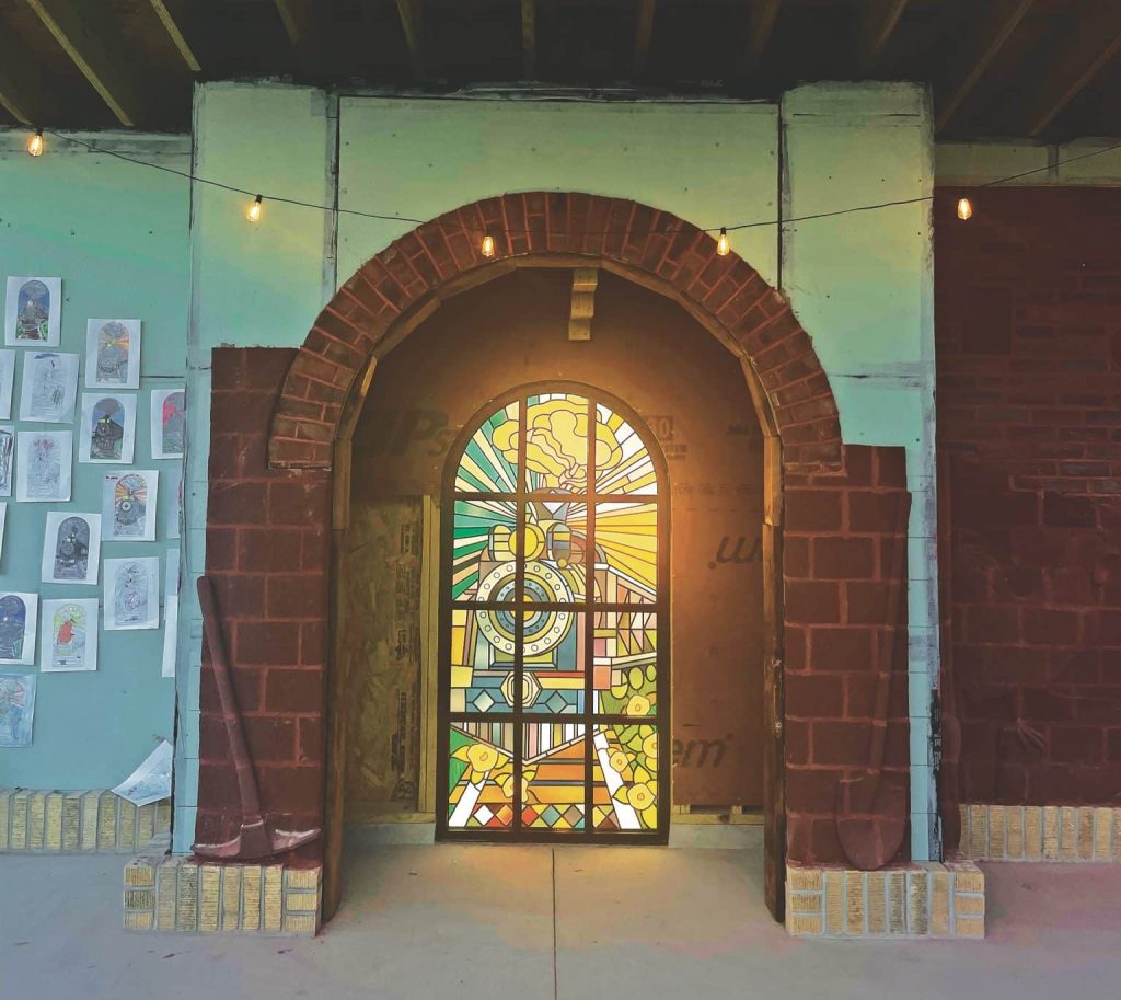 Stained-glass art, representing a nearby tunnel once used by coal trains, centers the new stage being built in Pound, Va. The stage will serve as a monument to the town's labor history as well as a local gathering place. Photo by Kara Dotten