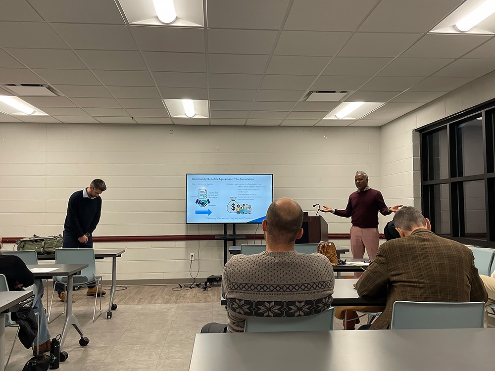 A representative from Ameresco Solar, the company that will install the solar panels on Richmond's capped landfill, speaks to community members during a December 2025 meeting.