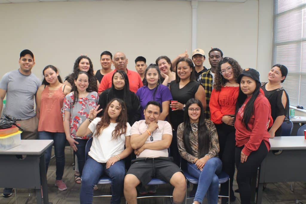 Group of English language learning students pose for photo 
