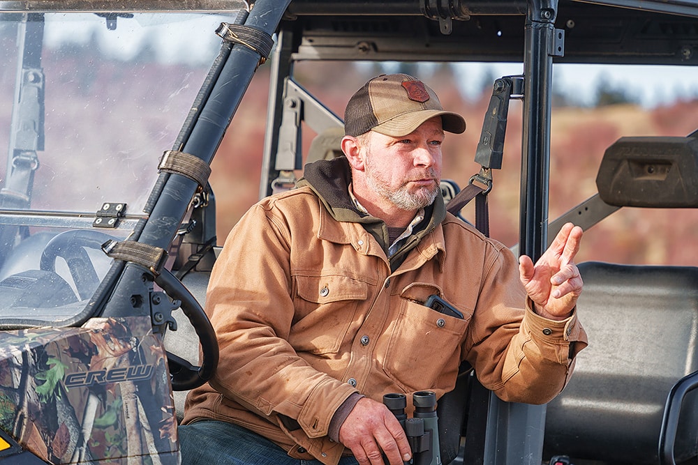 Man talking to people off camera sitting in an ATV