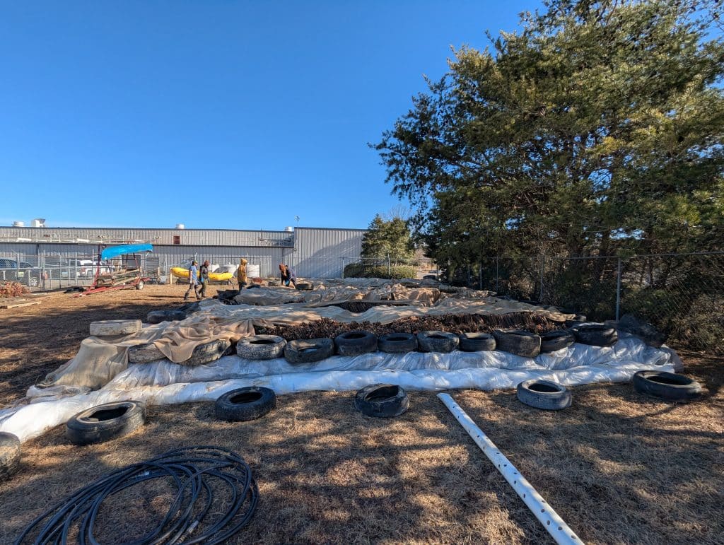 A temporary pond built partially from tires collected from rivers holds live stakes from native shrub and tree species at the MountainTrue cleanup headquarters. Photo by Erin Savage
