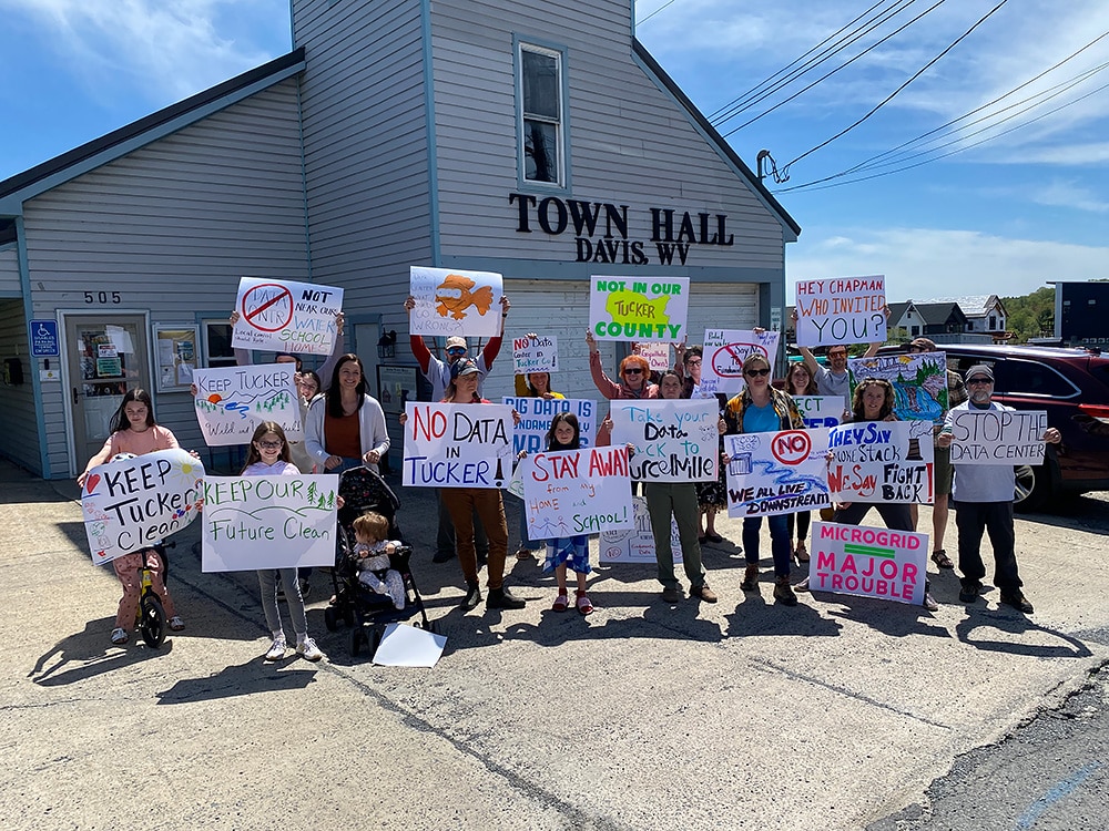 Residents gather at Davis Town Hall after a poster-making party to protest the proposed gas plant and data center.