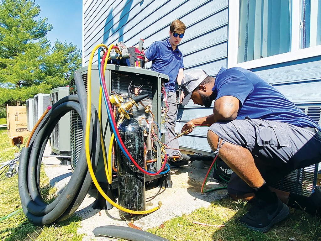 Quick AC Quote technicians install high-efficiency heat pumps at a home through the Weatherization Deferral Repair Program. Photo by Bradley Strahm/CHP