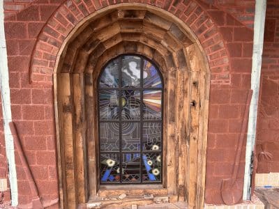 Stained glass depicting train coming out of a tunnel