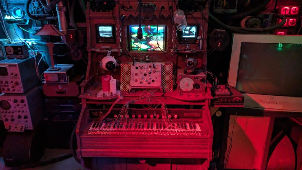 The Resonator, a century-old modified pump organ, is the centerpiece of one of the House of Art’s permanent exhibits, surrounded by creepy computer junk and red and blue and green neon lights
